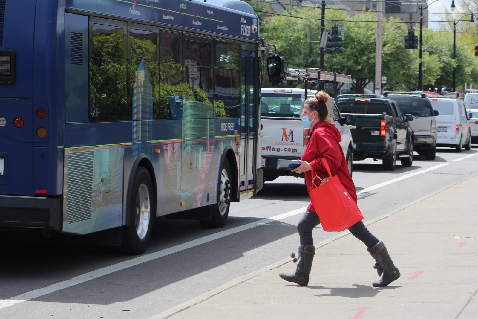 A DoorDash delivery driver picks up an order on Brown Street on Thursday. CORNELIUS FROLIK / STAFF