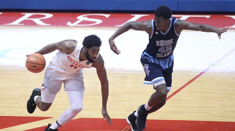 Dayton’s Josh Cunningham dribbles against Rhode Island’s Nicola Akele on Saturday, Jan. 20, 2018, at UD Arena. David Jablonski/Staff