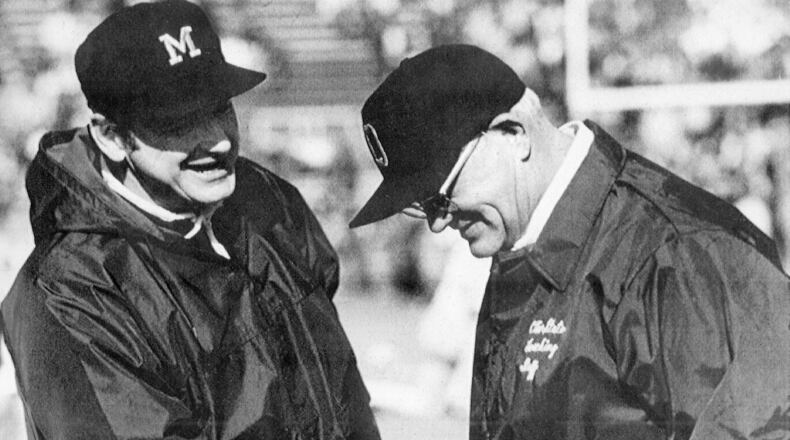 Michigan football coach Bo Schembechler, left, meets with Ohio State coach Woody Hayes in this undated file photo, location unknown. The 10 games featuring Hayes and Schembechler are remembered as the highlight of the series. The Buckeyes or Wolverines were in the Rose Bowl each year the two legendary coaches dueled for a win in one of college football’s greatest rivalries from 1969-78. (AP Photo)