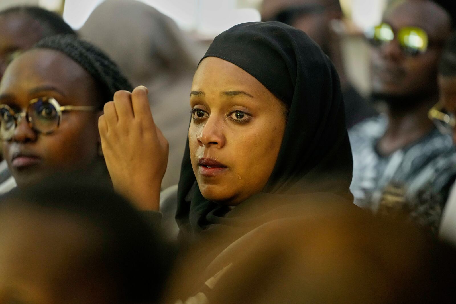 A woman cries during a funeral ceremony for Nigerian Ladi Anzaki Olubunmi, a TikTok content moderator employed by subcontractor Teleperformance, at Chiromo Funeral Parlour in Nairobi, Kenya Thursday, April. 17, 2025. (AP Photo/Brian Inganga)