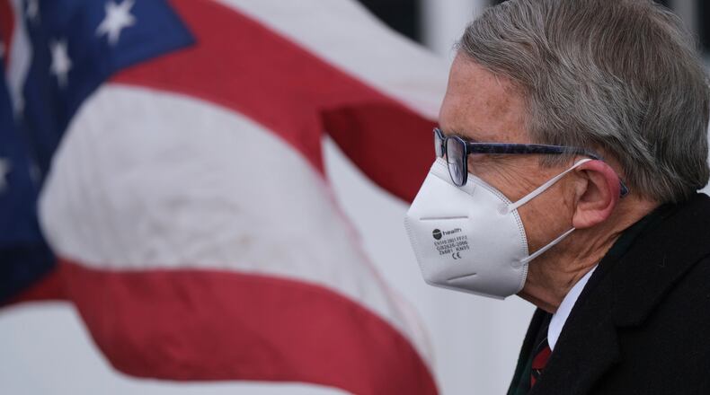 FILE-This Wednesday, Nov.18, 2020 file photo shows Ohio Gov. Mike DeWine looking on during a press conference at Toledo Express Airport in Swanton, Ohio. (J.D. Pooley/Sentinel-Tribune via AP)