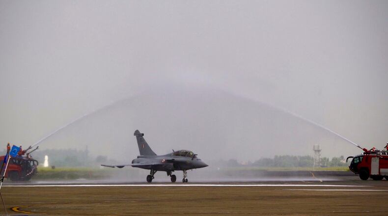 Water is sprayed on a French-made Rafale fighter jet during its induction ceremony at the Indian Air Force Station in Ambala, India, Thursday, Sept.10, 2020. The first batch of five planes, part of a $8.78 billion deal signed between the two countries in 2016 had arrived here in July. (AP Photo/Manish Swarup)