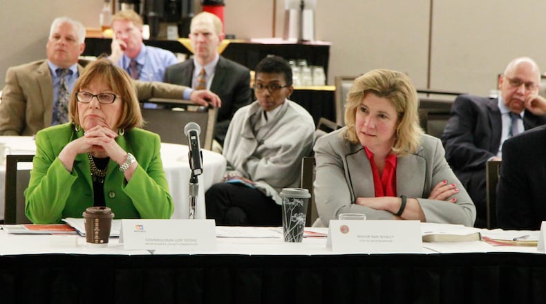 Montgomery County Commission President Judy Dodge and Dayton Mayor Nan Whaley listen to public health officials discuss the heroin epidemic at a joint work session recently. Lebanon is considering joining Dayton and other companies suing drug manufacturers over the opioid epidemic. STAFF