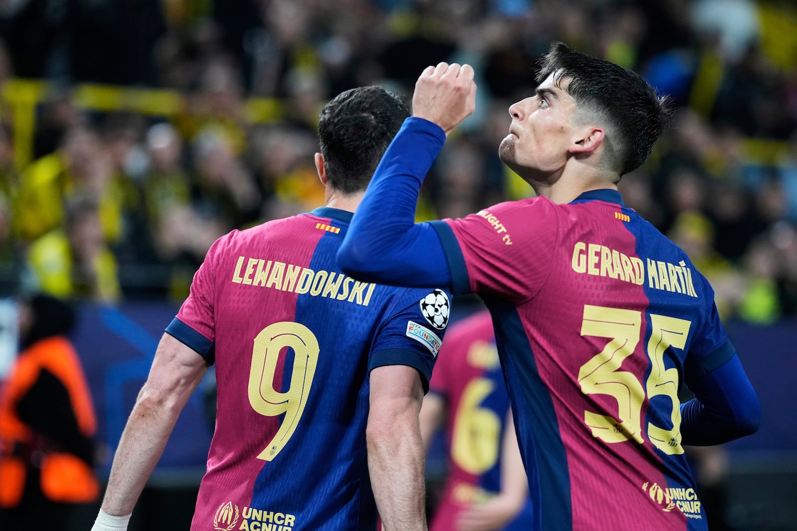 Barcelona's Gerard Martin celebrates after forcing an own goal by Dortmund's Ramy Bensebaini during the Champions League quarterfinals second leg soccer match between Borussia Dortmund and Barcelona, at the Signa-Iduna Park in Dortmund, Germany, Tuesday, April 15, 2025. (AP Photo/Matthias Schrader)