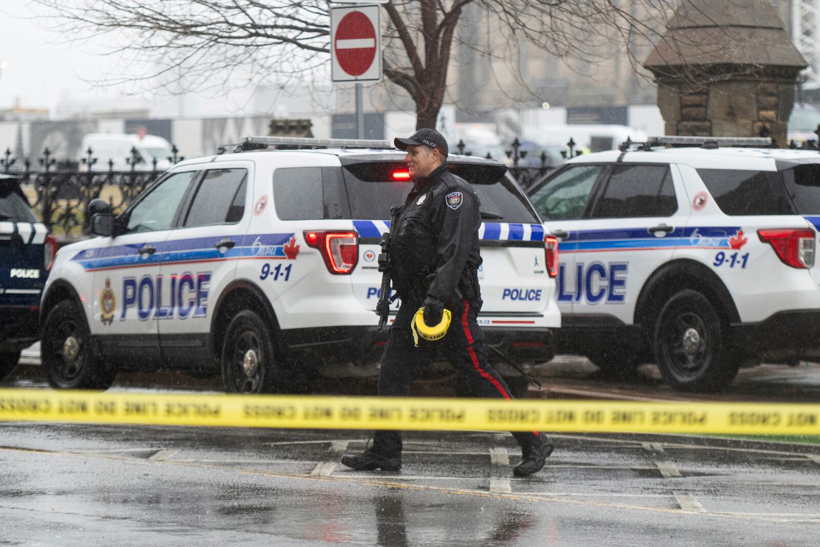 An Ottawa Police Service officer works the scene after a man barricaded himself in Parliament Hill in Ottawa, Ontario, Saturday, April 5, 2025. (Spencer Colby/The Canadian Press via AP)