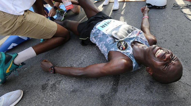 July 04, 2017 Atlanta: Leonard Korir collapses to the street after the finish line winning the 48th running of the AJC Peachtree Road Race with an unofficial time of 28:16 on Tuesday, July 4, 2017, in Atlanta. Curtis Compton/ccompton@ajc.com