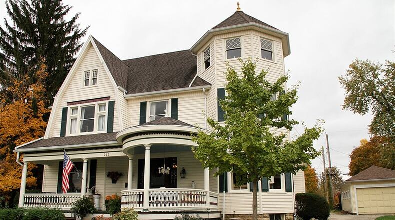 The 3-story home has a covered porch, a private back yard and a 2-story carriage house. The carriage house has 2 overhead garage-doors, double-door entry and walk-up loft storage. CONTRIBUTED PHOTOS BY KATHY TYLER