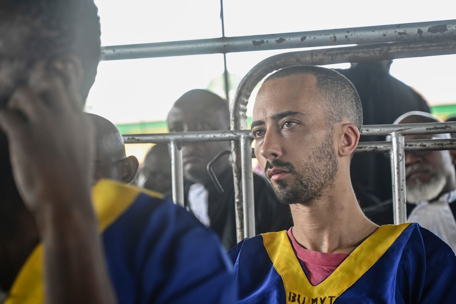 FILE - Benjamin Reuben Zalman-Polun sits in court in Kinshasa with 52 other defendants Friday June 7, 2024, accused of a role in last month's attempted coup in Congo led by little-known opposition figure Christian Malanga in which six people were killed. (AP Photo/Samy Ntumba Shambuyi, File)