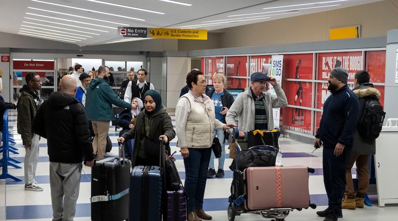 People walk out of the terminal upon their arrival from Amman, Jordan at John F. Kennedy International Airport in New York, Thursday, March 5, 2026. (AP Photo/Yuki Iwamura)