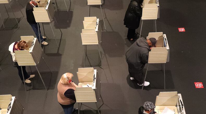Voters fill up most of the privacy booths at Clark State's Turner Studio Theater during the first day of early voting Tuesday. BILL LACKEY/STAFF