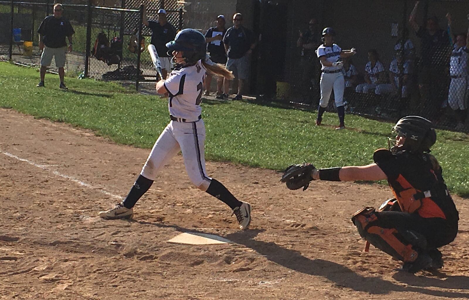 Edgewood’s Jenna Smith (27) takes a cut before the ball can reach Loveland catcher Jerrah Harcourt on Monday in St. Clair Township. Smith’s Cougars won 9-6 in a Division I sectional opener. RICK CASSANO/STAFF