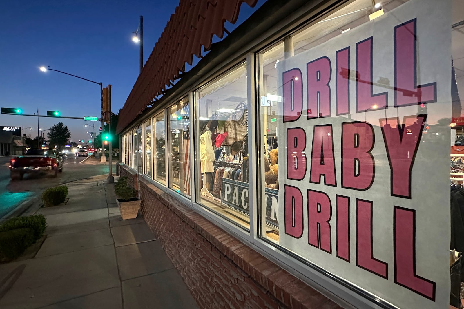 A sign in support of the oil and natural gas industry is displayed in a shop window along a main street in Carlsbad, N.M., on Tuesday, May 20, 2025. (AP Photo/Susan Montoya Bryan)