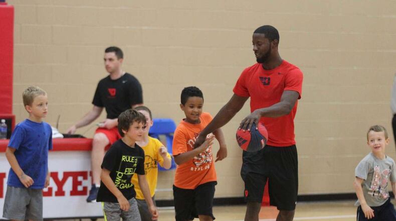Dayton guard Scoochie Smith works with kids at a youth basketball camp at UD’s Cronin Center on Tuesday, July 19, 2016, in Dayton. David Jablonski/Staff