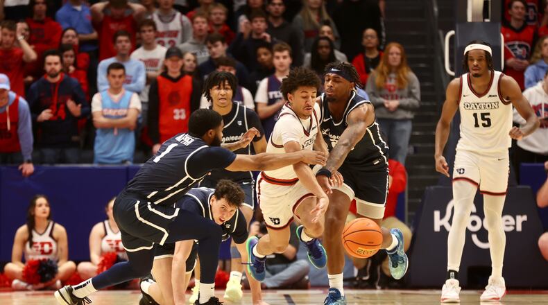 Dayton's Javon Bennett comes up with a loose ball against Longwood on Saturday, Dec. 30, 2023, at UD Arena. David Jablonski/Staff