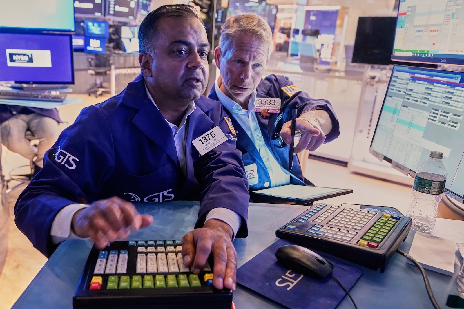 Specialist Dilip Patel, left, and trader Robert Charmak work on the floor of the New York Stock Exchange, Monday, June 23, 2025. (AP Photo/Richard Drew)