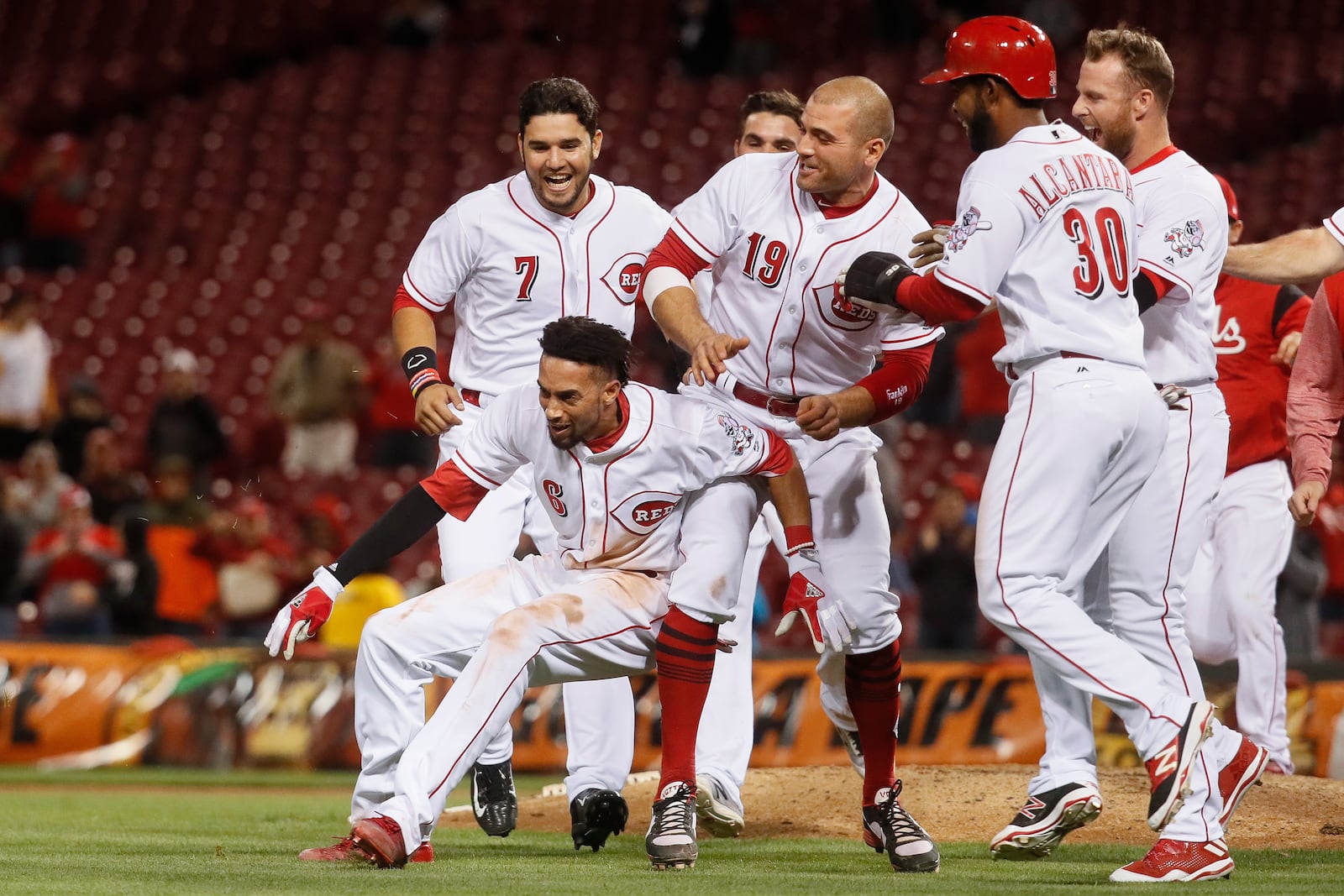 Cincinnati Reds’ Billy Hamilton (6) celebrates with Joey Votto (19) after hitting the game-winning RBI single in the 10th inning of a baseball game, Monday, May 1, 2017, in Cincinnati. The Reds won 4-3. (AP Photo/John Minchillo)