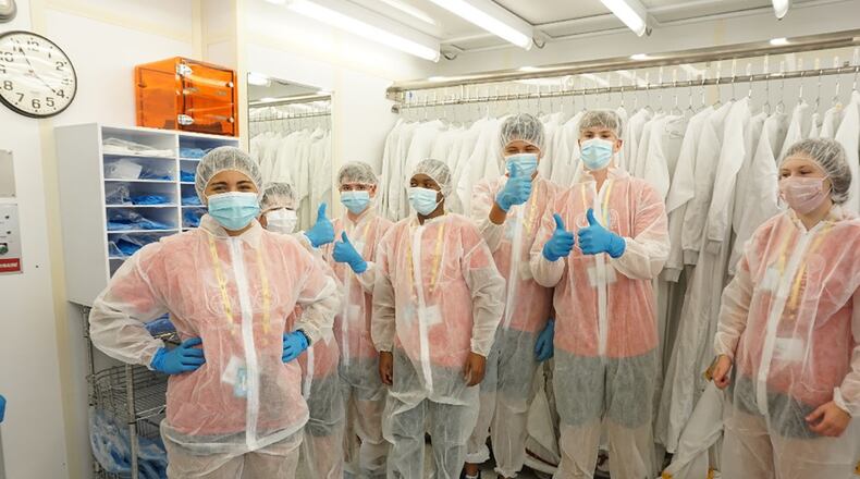 Air Camp students gown up to take a tour of the class 100 clean room at the Air Force Research Laboratory’s Sensors Directorate facility at Wright-Patterson Air Force Base. The students learned about science, technology, engineering and math, or STEM, careers within AFRL during their tour. CONTRIBUTED PHOTO