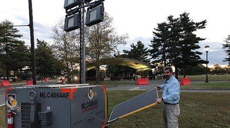 Jeff Hill, lead engineer from the Air Force Life Cycle Management Center’s Support Equipment Program Office, collects data from the hybrid cart and displays solar panels on the Advanced Flight line Power and Light System at gates at Joint Base McGuire-Dix-Lakehurst, New Jersey. (U.S. Air Force photo/Master Sgt. John Bono)