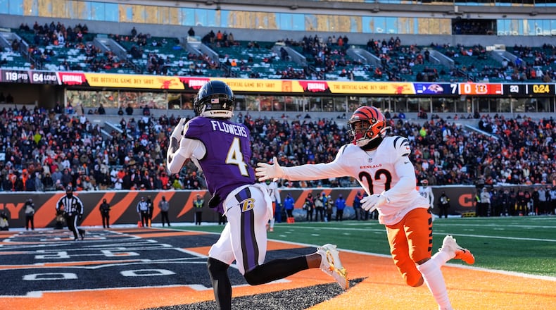 Baltimore Ravens wide receiver Zay Flowers (4) makes a catch for a touchdown past Cincinnati Bengals safety Geno Stone (22) during the first half of an NFL football game, Sunday, Dec. 14, 2025, in Cincinnati. (AP Photo/Carolyn Kaster)