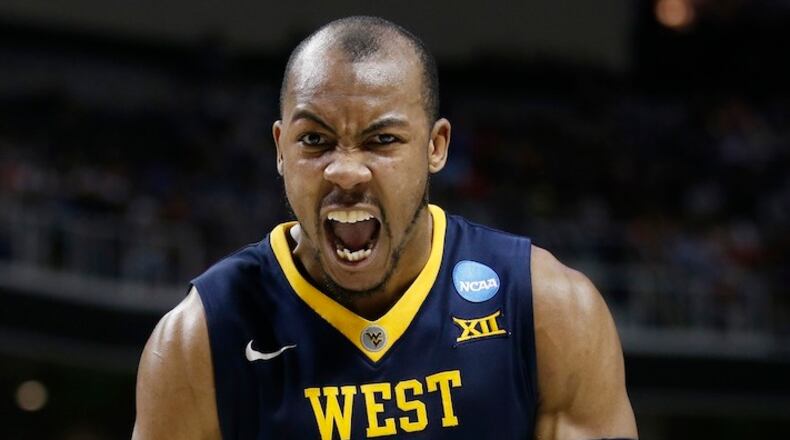 FILE - This March 23, 2017 file photo shows West Virginia guard Jevon Carter (2) celebrating after scoring against Gonzaga during the second half of an NCAA Tournament college basketball regional semifinal game in San Jose, Calif. College basketball's version of decision day could go a long way toward shaping how the next season will play out. West Virginia has a few pieces to replace in its Press Virginia defense, but Jevon Carter won't be one of them. (AP Photo/Tony Avelar, file)