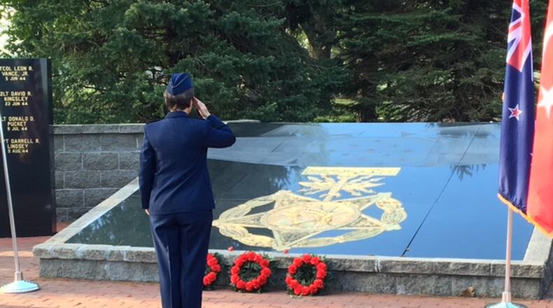 U.S. Air Force Col. Trisha Sexton salutes after laying a red poppy next to three wreaths to commemorate ANZAC Day on April 25, 2017 at the National Museum of the U.S. Air Force. In the year marking the 100th anniversary of the U.S. entry into World War I, about 100 people, some wearing the uniforms of foreign militaries, marked ANZAC Day. The day commemorates the first major battle Australian and New Zealand troops fought in World War I. BARRIE BARBER/STAFF