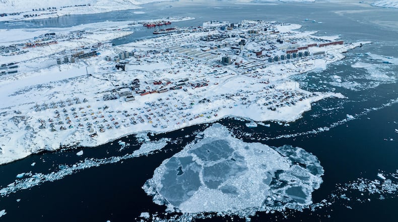 FILE - Houses covered by snow are seen on the coast of a sea inlet of Nuuk, Greenland, on March 7, 2025. (AP Photo/Evgeniy Maloletka, File)