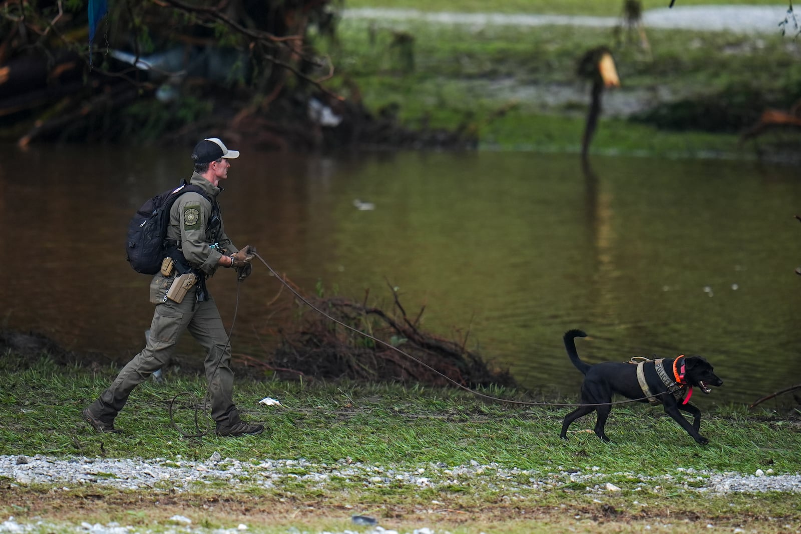 Officials comb through the banks of the Guadalupe River after a flash flood swept through the area Saturday, July 5, 2025, in Hunt, Texas. (AP Photo/Julio Cortez)