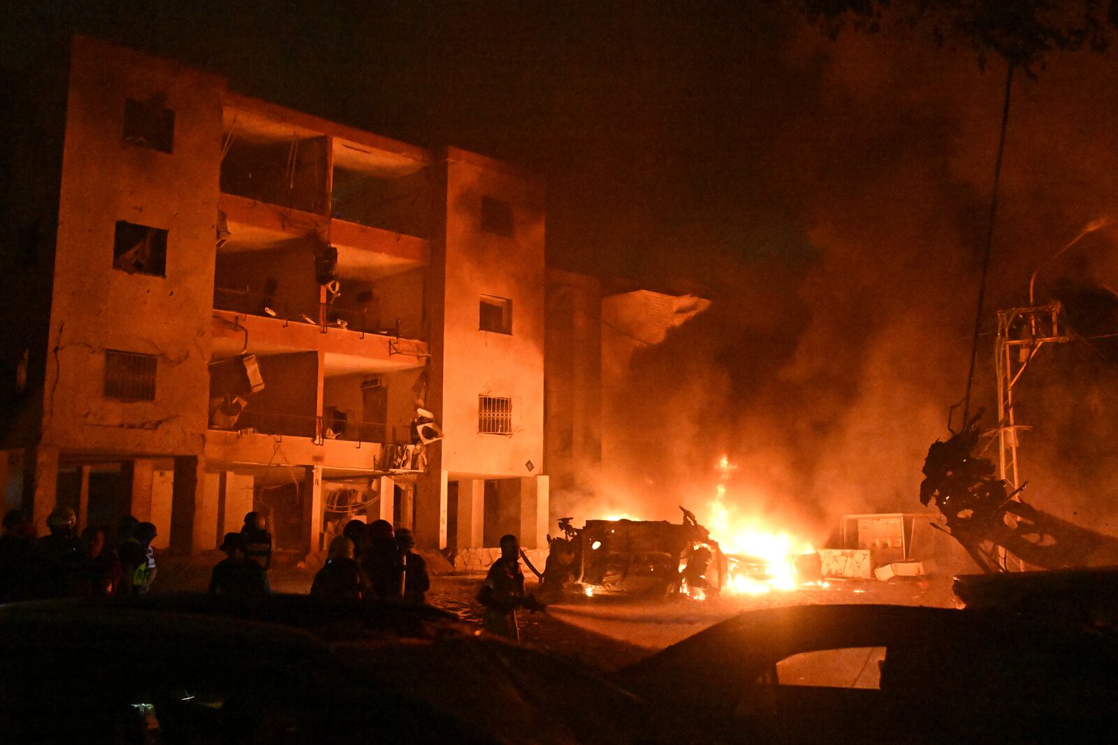Firefighters work to extinguish a blaze after a missile launched from Iran struck Haifa, in northern Israel, on Sunday, June 15, 2025. (AP Photo/Rami Shlush)
