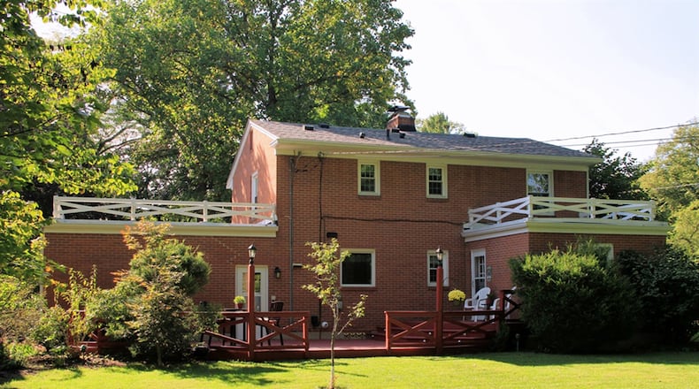 A split door off the den opens to the multi-level wooden deck and the open back yard.