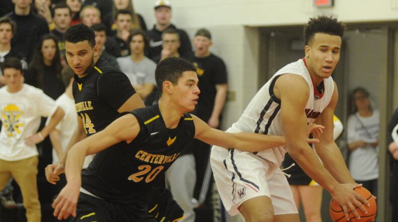 Wayne’s L’Christian “Blue” Smith (with ball) draws the attention of Centerville’s Jevon Henderson (left) and Adam Velasco (20). Wayne defeated visiting Centerville 42-38 in a boys high school basketball game on Tuesday, Jan. 24, 2017. MARC PENDLETON / STAFF
