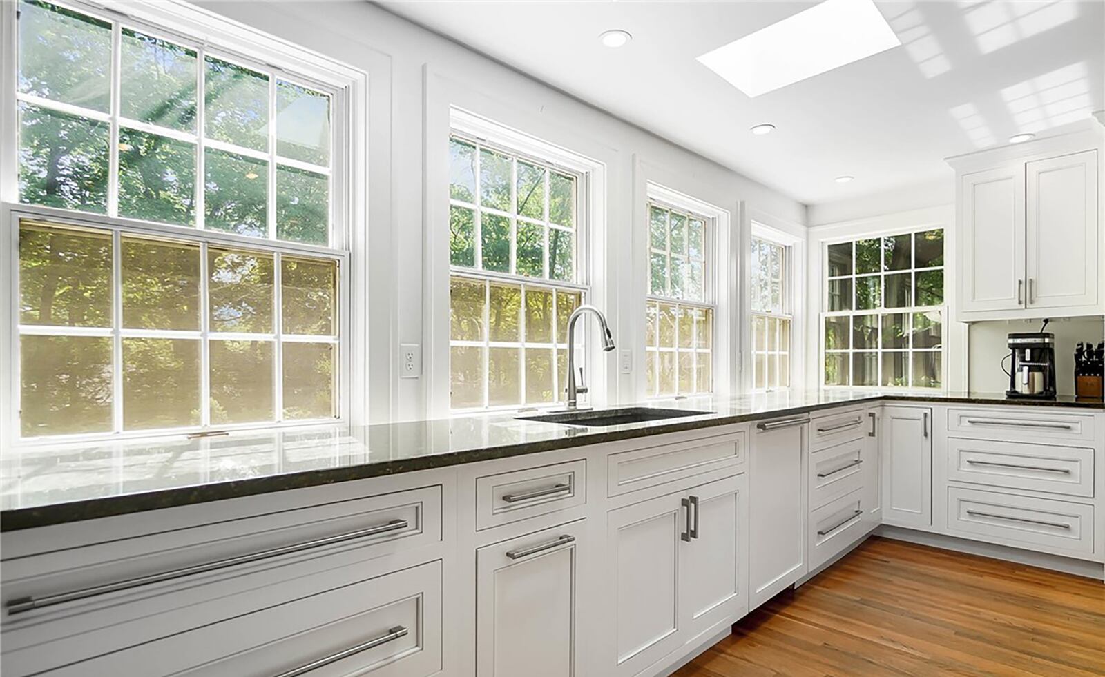 The kitchen has been completely updated with high end appliances and granite countertops and has a wall of windows to let in natural light.