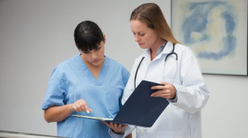 A nurse consults with a doctor. PHOTO/PROVIDED