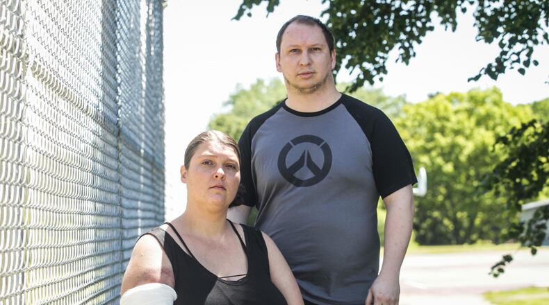 Tiffany and Zach Guithues from Dayton were struck by gun-fired bean bags during a protest Saturday on Keowee Street in Dayton. Tiffany said she had a bag removed from her arm at the hospital. JIM NOELKER/STAFF