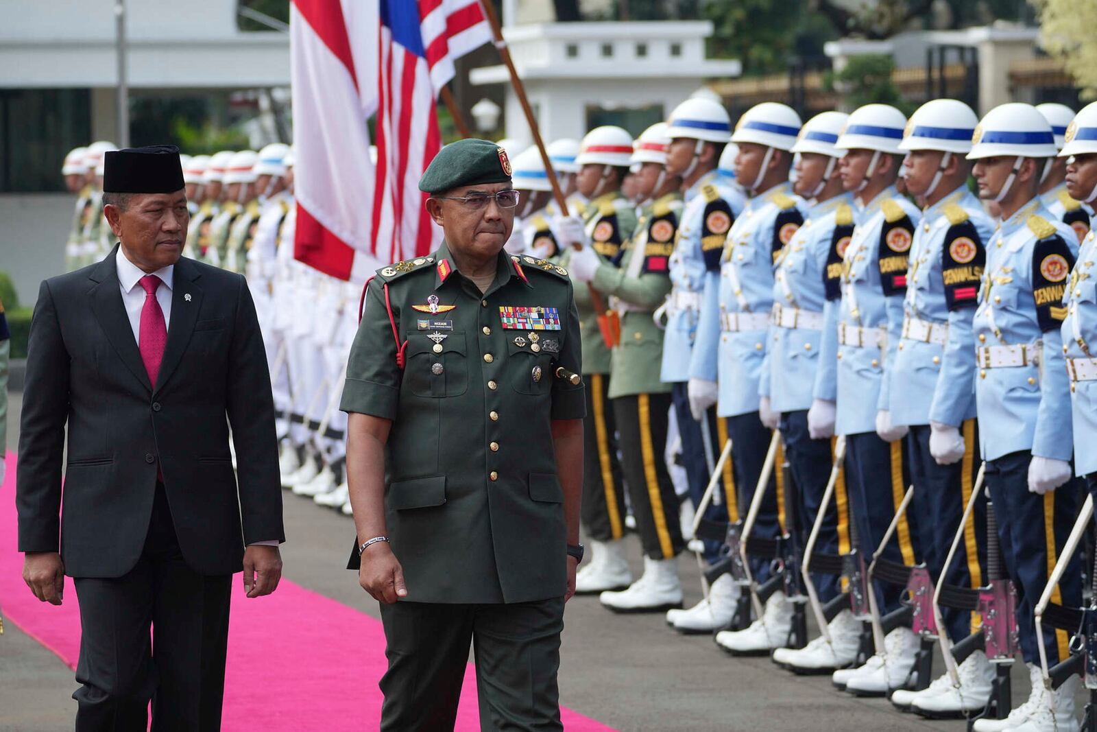 Malaysia's Chief of Defence Force Mohd Nizam Jaffar, right, and Indonesia's Deputy Defense Minister Donny Ermawan Taufanto inspect honor guards during a welcoming ceremony prior to their meeting in Jakarta, Indonesia, Wednesday, April 16, 2025. (AP Photo/Achmad Ibrahim)