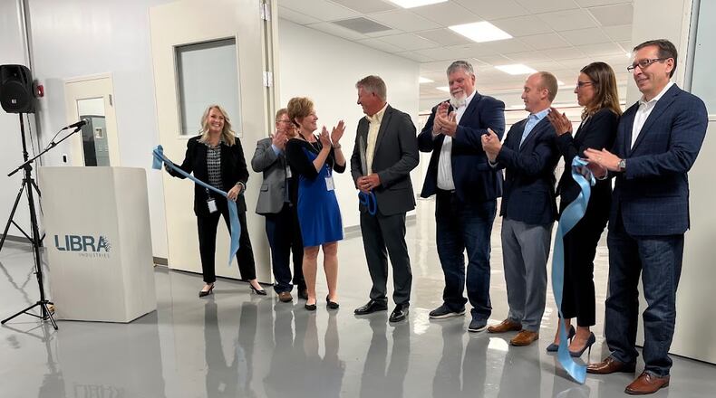 The ribbon is cut: LIbra Industries and Dayton leaders celebrate the opening of a new $1.8 million clean room to support semiconductor fabrication work in Dayton Thursday. THOMAS GNAU/STAFF