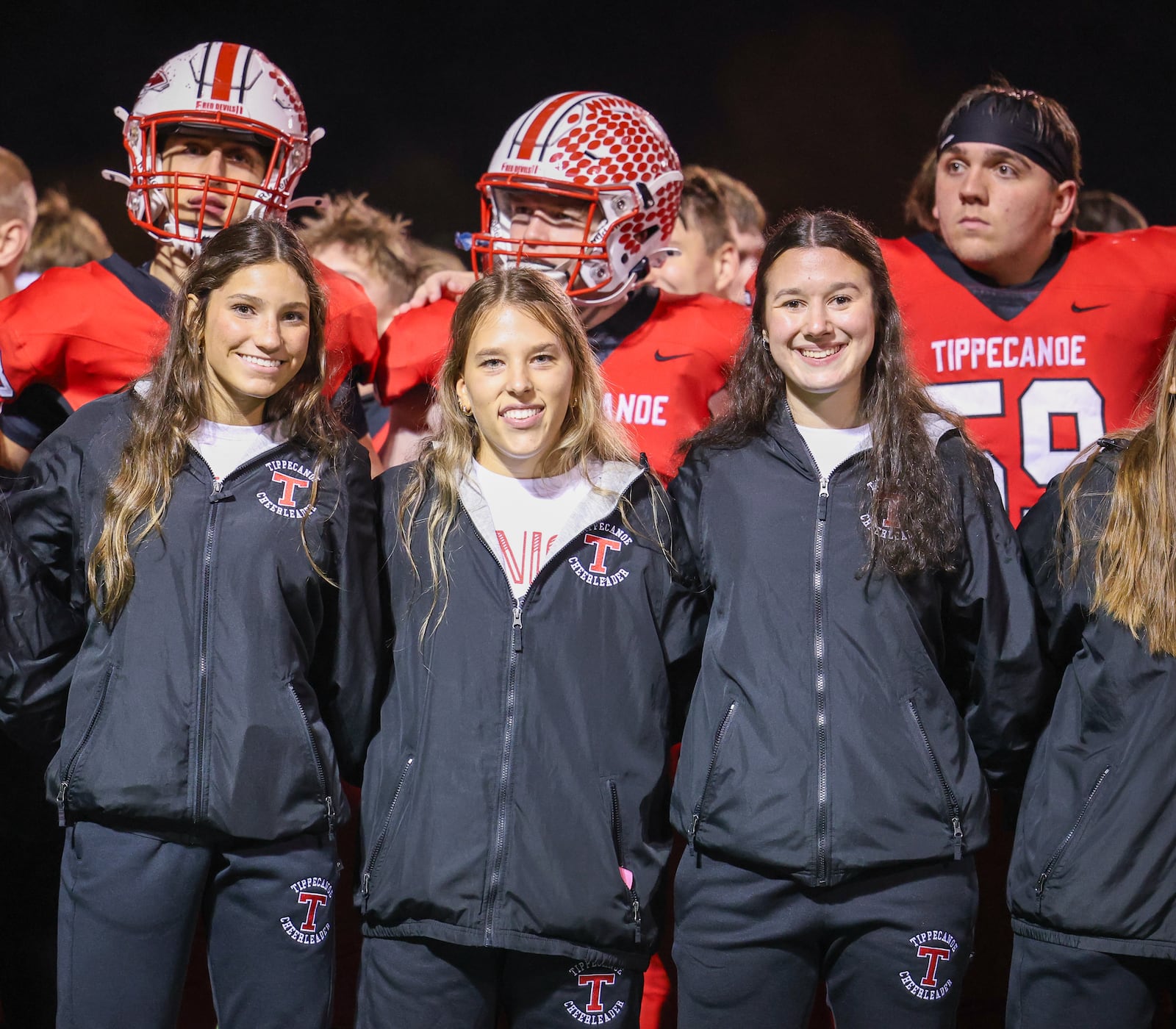 Tipppecanoe cheerleaders and players sing the school's alma mater following a 55-7 win over Oxford Talawanda in a Division III, Region 12 playoff game on Friday, Nov. 7 at Tipp City Park. BRYANT BILLING/STAFF