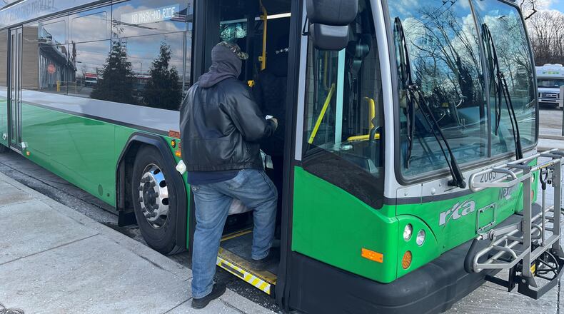 A passenger boards a bus at the Eastown Transit Center. CORNELIUS FROLIK / STAFF