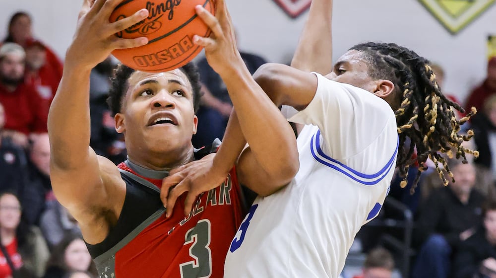 Northridge sophomore guard Keonte Smith shoots Dunbar's Chrishod Averette during a Division IV district semifinal on Tuesday, March 3 at Sidney High School. BRYANT BILLING / STAFF