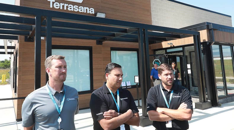 The owners of Terrasana, the new medical marijuana dispenary at 183 Raydo Circle in Springfield, talk about the opening day on Thursday. The owners are, from left, Craig Mauer, Bill Kedia and Todd Yaross. BILL LACKEY/STAFF
