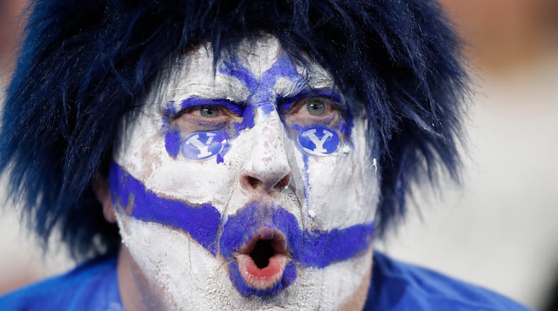 A BYU fan cheers during the second half of an NCAA college football game against TCU Saturday, Nov. 15, 2025, in Provo, Utah. (AP Photo/George Frey)