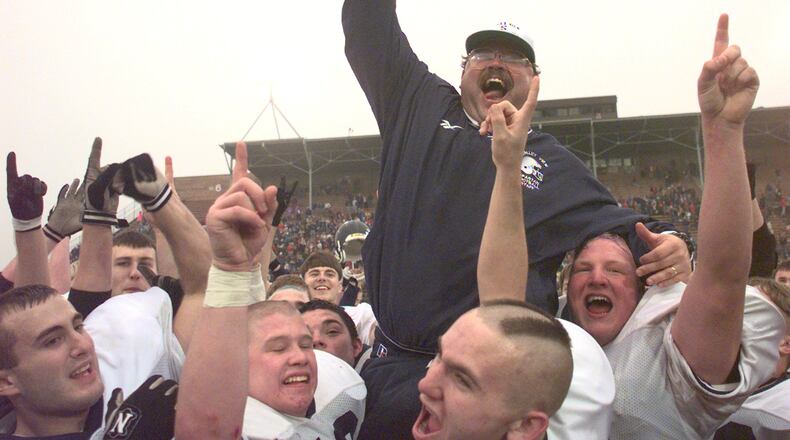 Valleyview Head Coach Jay Niswonger holds the championship trophy after winning the Division 4 state championship game against the Manchester Panthers in a record 5 overtime periods. STAFF FILE PHOTO