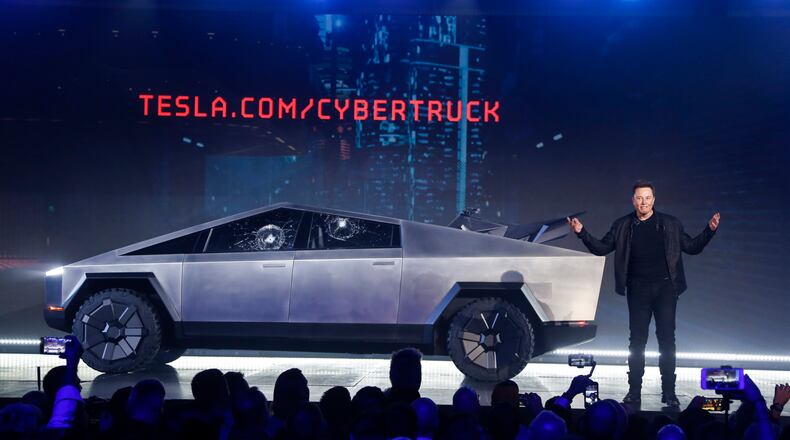 In this Nov. 21, 2019 file photo, Tesla CEO Elon Musk introduces the Cybertruck at Tesla’s design studio in Hawthorne, Calif. The much-hyped unveil of Teslas electric pickup truck went off script when supposedly unbreakable window glass shattered twice when hit with a large metal ball. The failed stunt, which ranks high on the list of embarrassing auto industry rollouts, came just after Musk bragged about the strength of Tesla Armor Glass on the wedge-shaped Cybertruck. (AP Photo/Ringo H.W. Chiu, File)