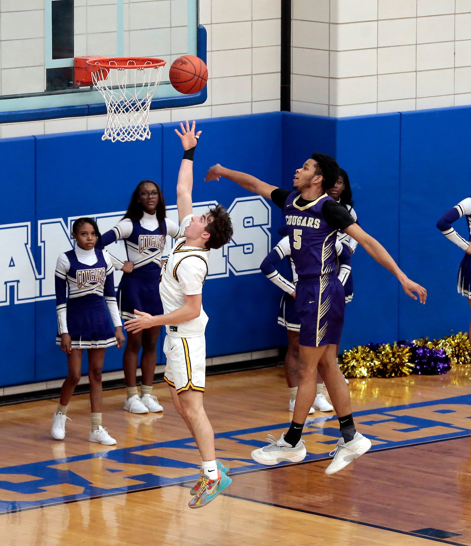 Alter junior Peyton Bakos drives in for a layup past Thurgood Marshall junior Christian Rivera. Alter defeated Thurgood Marshall 74-40 in a Division IV district tournament game on Thursday, Feb. 26, 2026, in Xenia. STEVEN WRIGHT / STAFF