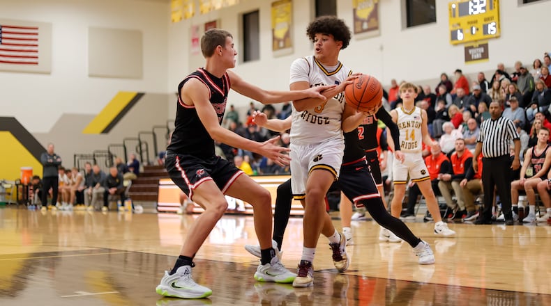 Kenton Ridge senior Caleb Hall is defended by Tecumseh senior Corey Russell during their game on Friday, Dec. 5, 2025 in Springfield. The Cougars won 69-60. MICHAEL COOPER / STAFF PHOTO