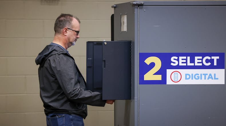 A voter waits for a printout from a digital machine at a polling location at New Season Ministry in Huber Heights on Tuesday, May 6. BRYANT BILLING / STAFF