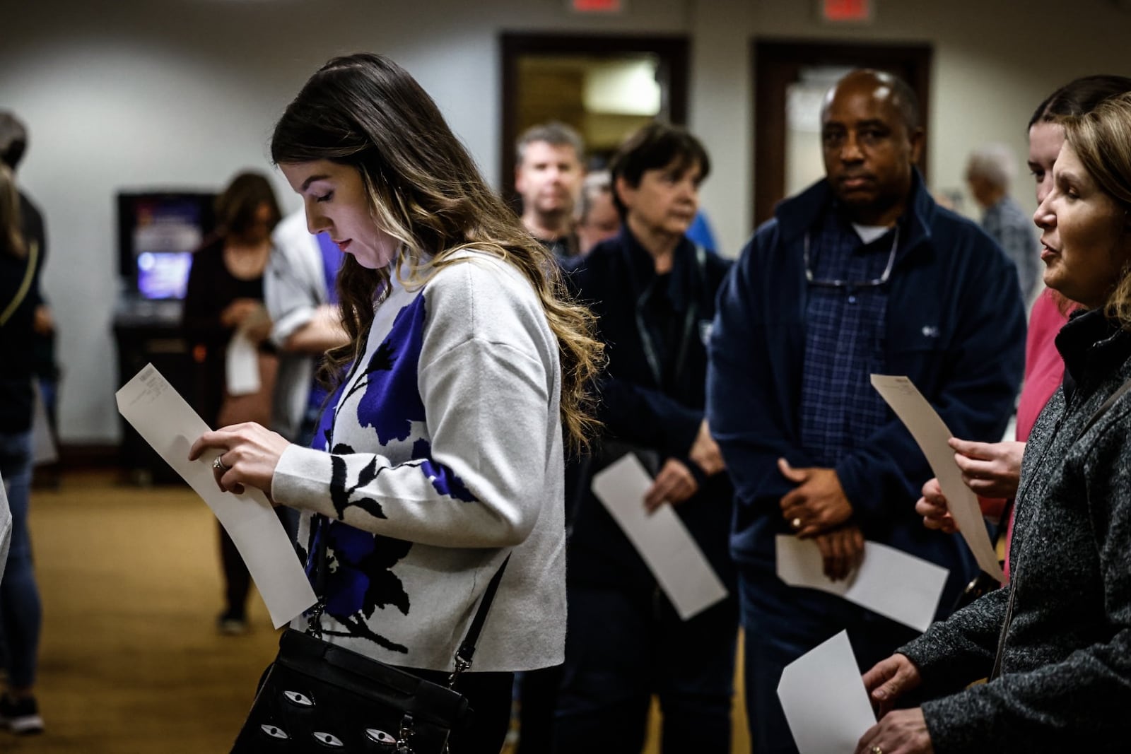 Leeanna Price, left, stands in line to case her ballot Tuesday evening at St. Leonard in Centerville. Jim Noelker/Staff