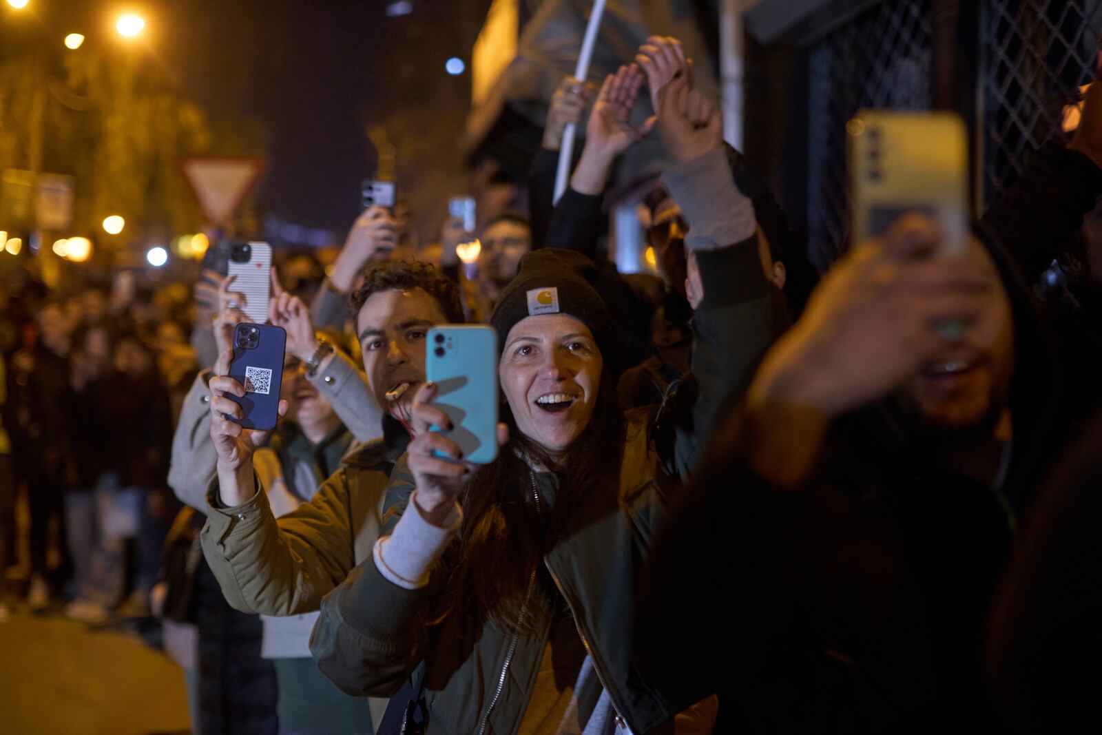 Locals chant and greet a group of students who walked across the country as they arrive at an anti-corruption protest in the southwestern town of Novi Pazar, Serbia, Friday, April 11, 2025. (AP Photo/Marko Drobnjakovic)