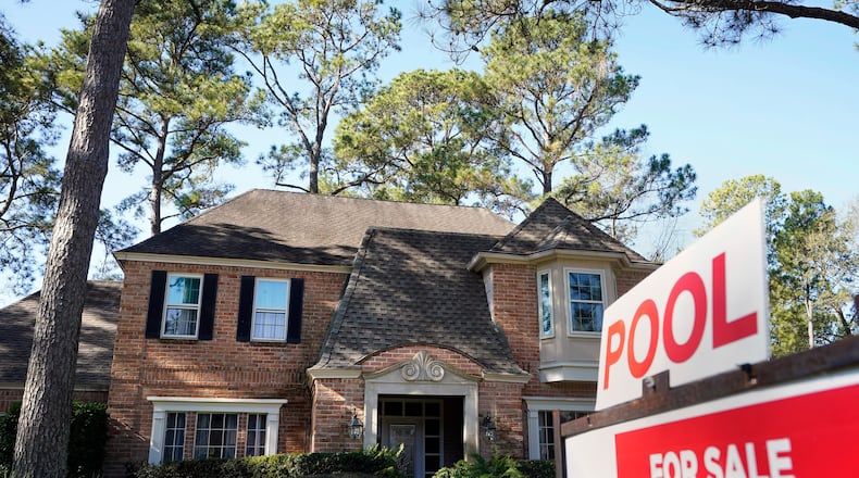 FILE - A real estate sign is shown at a home for sale in Houston, Jan. 13, 2021. (Melissa Phillip/Houston Chronicle via AP, File)