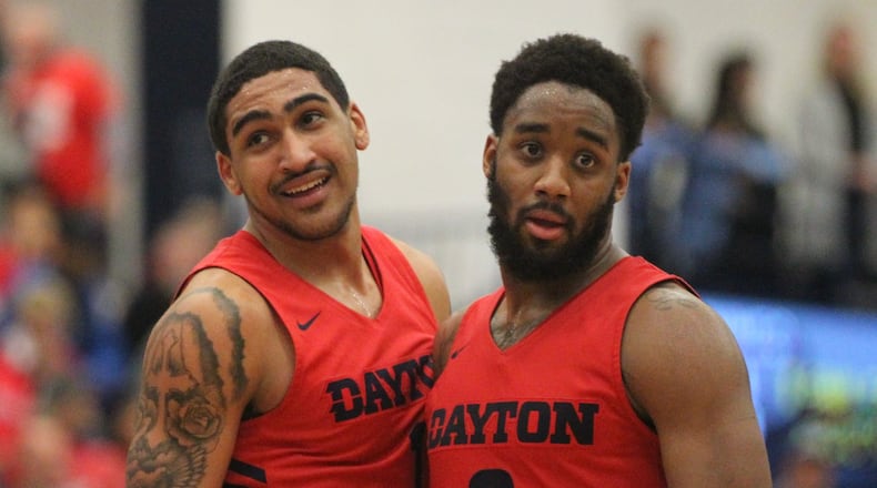 Dayton’s Obi Toppin and Josh Cunningham react during the final minute of a victory against Duquesne on Saturday, March 9, 2019, at the A.J. Palumbo Center in Pittsburgh. David Jablonski/Staff