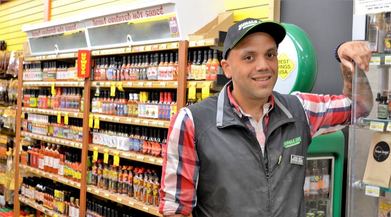 Mike Belen, the hot sauce and barbecue sauce buyer for Jungle Jim s International Market, works to keep the grocer s Fairfield and Eastgate locations stocked with more than 1,500 fiery food items, including hot sauces, barbecue sauces, spices and rubs, wing sauces, salsas and mustards. CONTRIBUTED